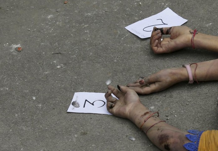Identification numbers are seen next to dead bodies after an earthquake struck, outside a hospital in Kathmandu
